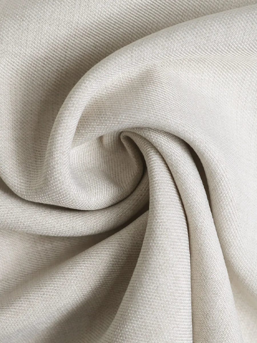 Close-up of beige fabric with a textured pattern