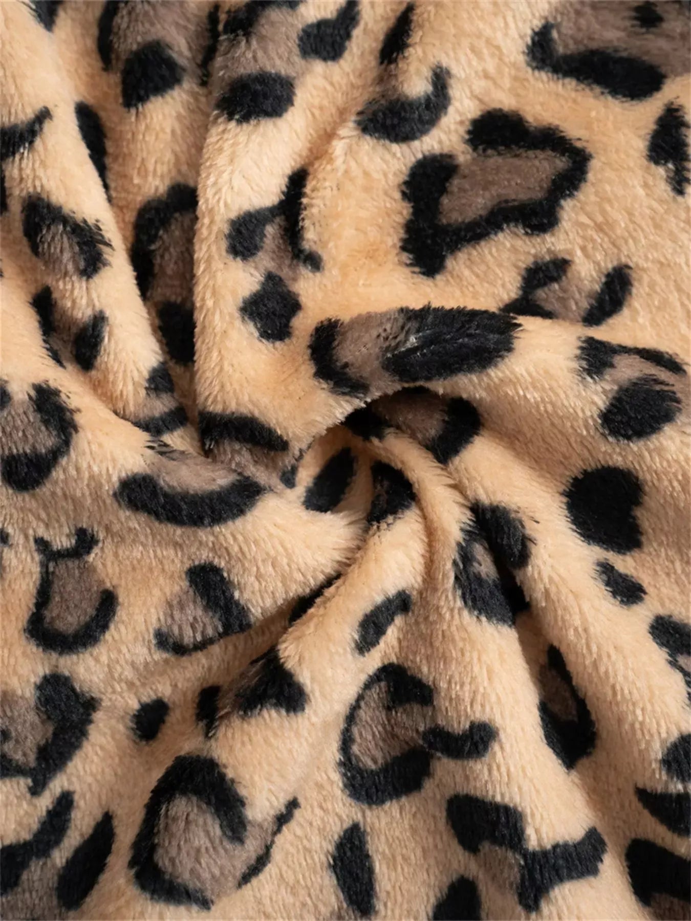 Close-up of leopard print fabric with beige background
