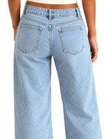 Rear view of a person wearing light-wash blue wide-leg jeans against a plain white background.