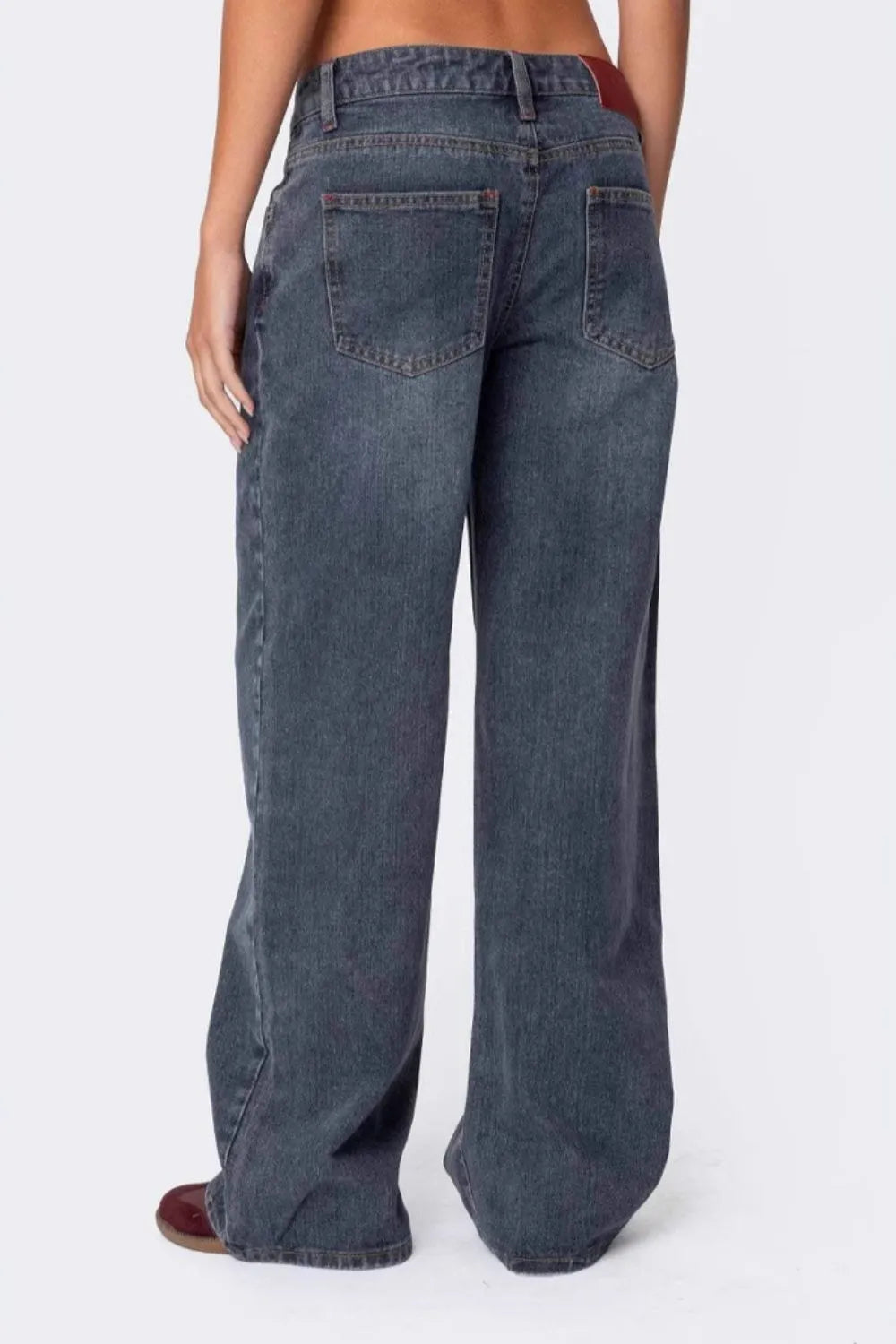 Blue jeans worn by a person on a white background