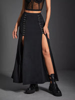 Person wearing a black lace-up skirt with a high slit on a gray background