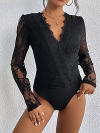 Black lace bodysuit worn by a model against a white background