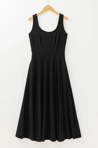 Black sleeveless dress on a wooden hanger against a white background