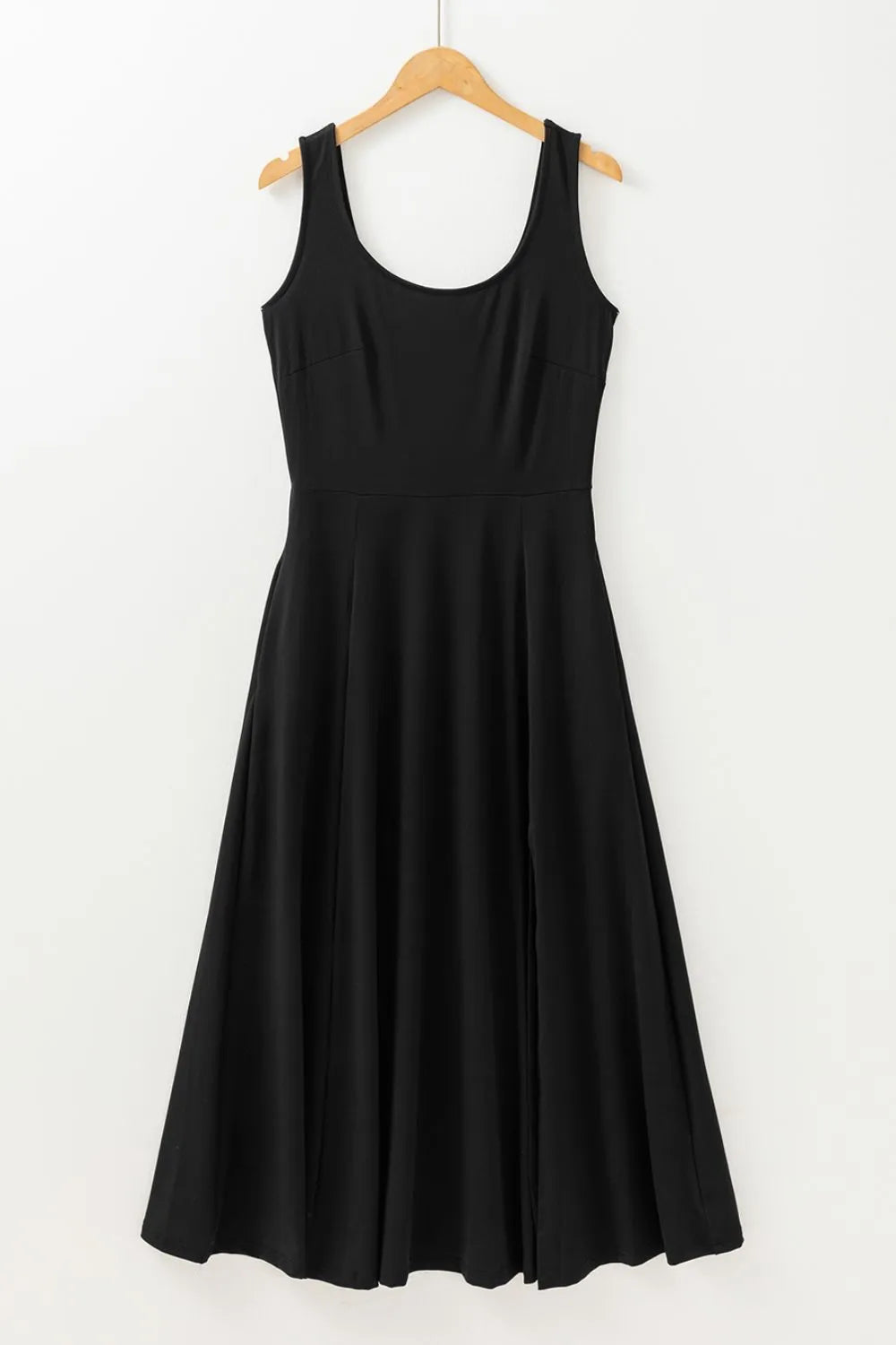 Black sleeveless dress on a wooden hanger against a white background