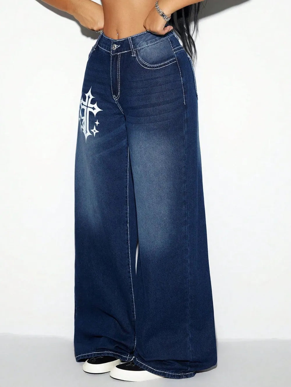 Blue jeans with a white cross design on a white background