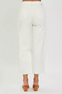 White pants worn by a person on a white background