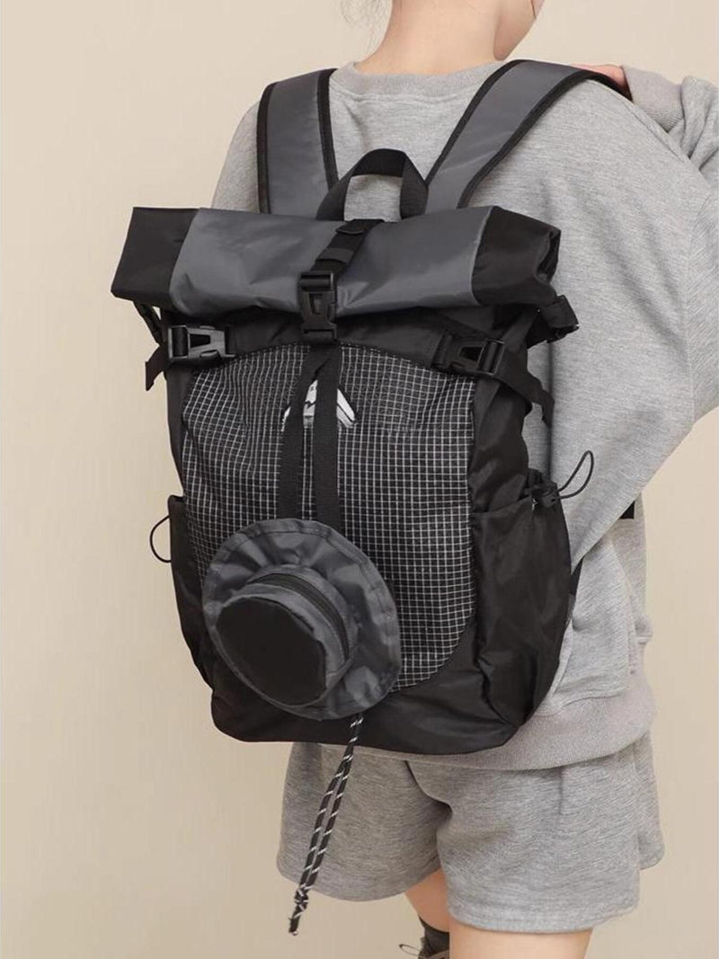 Person wearing a black and gray backpack on a beige background