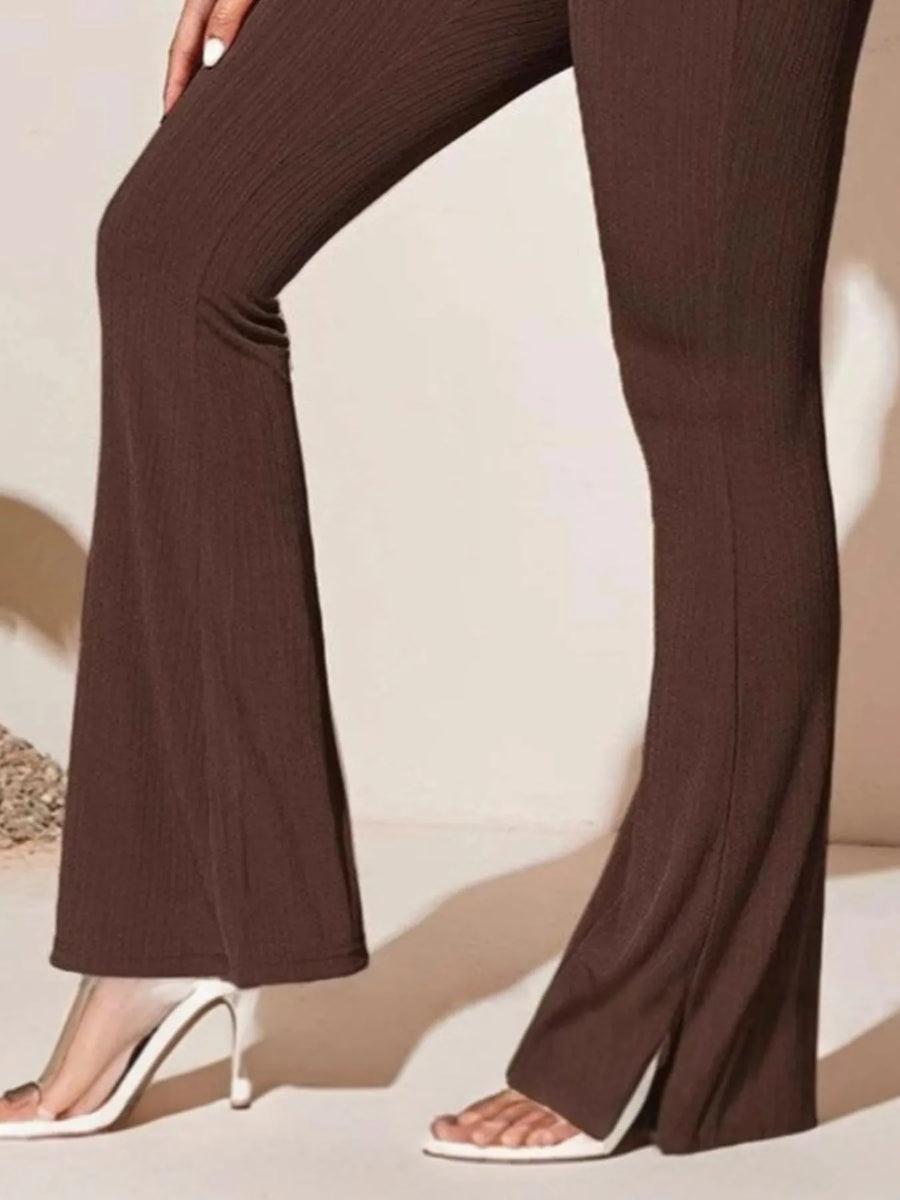 Brown flared pants worn by a person on a neutral background