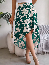 Person wearing a green floral skirt with a white background