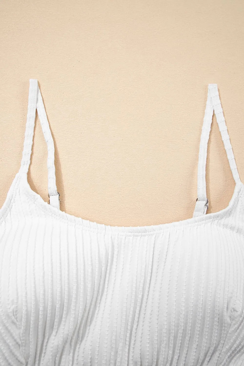 White ribbed tank top on a beige background