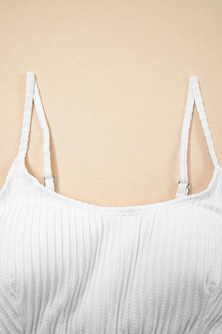White ribbed tank top on a beige background