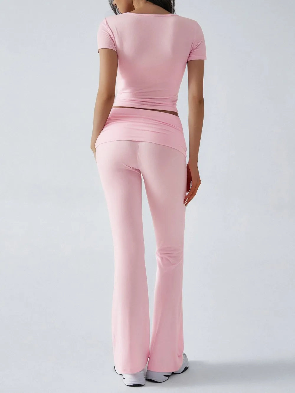 Person wearing a pink outfit on a white background