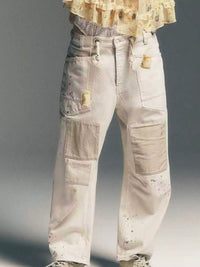 Close up view of woman in white patched jeans