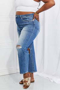 Person wearing blue jeans with a white background
