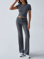Woman wearing a gray athletic outfit on a white background