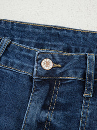 Close-up of a blue denim button on a white background