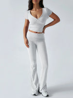 Woman wearing a white outfit with a plain background