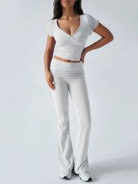 Woman wearing a white outfit with a plain background