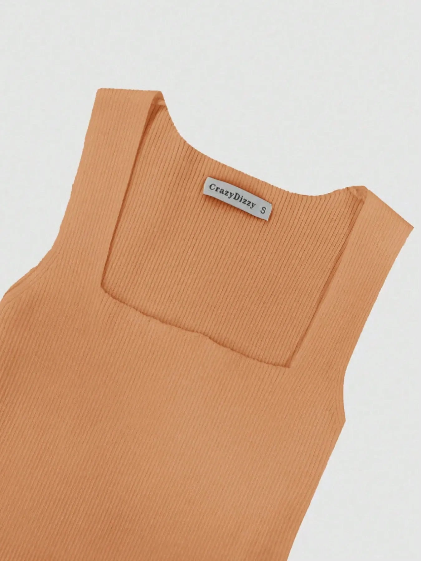 Brown sleeveless top with a brand label on a light gray background