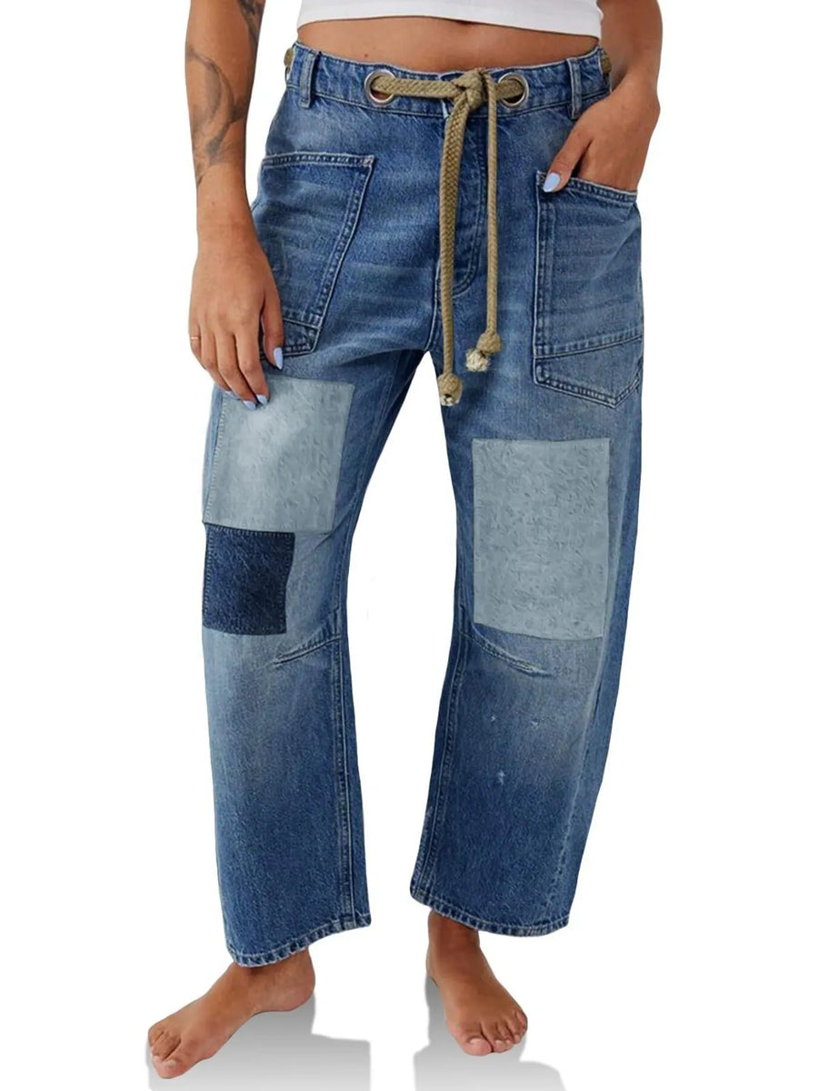 Patchwork jeans worn by a person on a white background