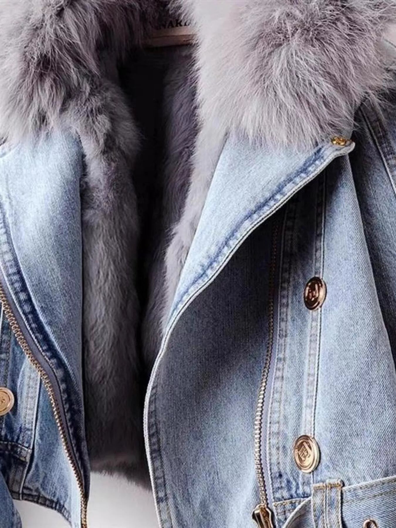 Denim jacket with fur lining and gold buttons on a white background
