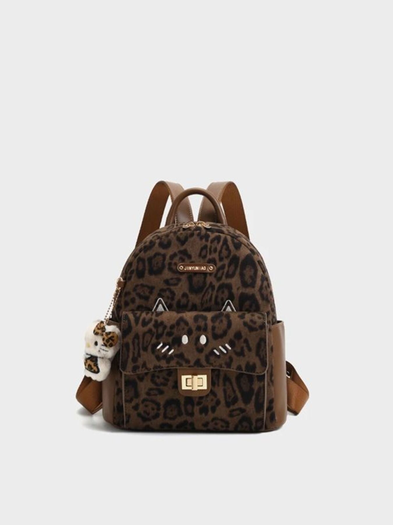 Leopard print backpack with a small plush toy on a light gray background