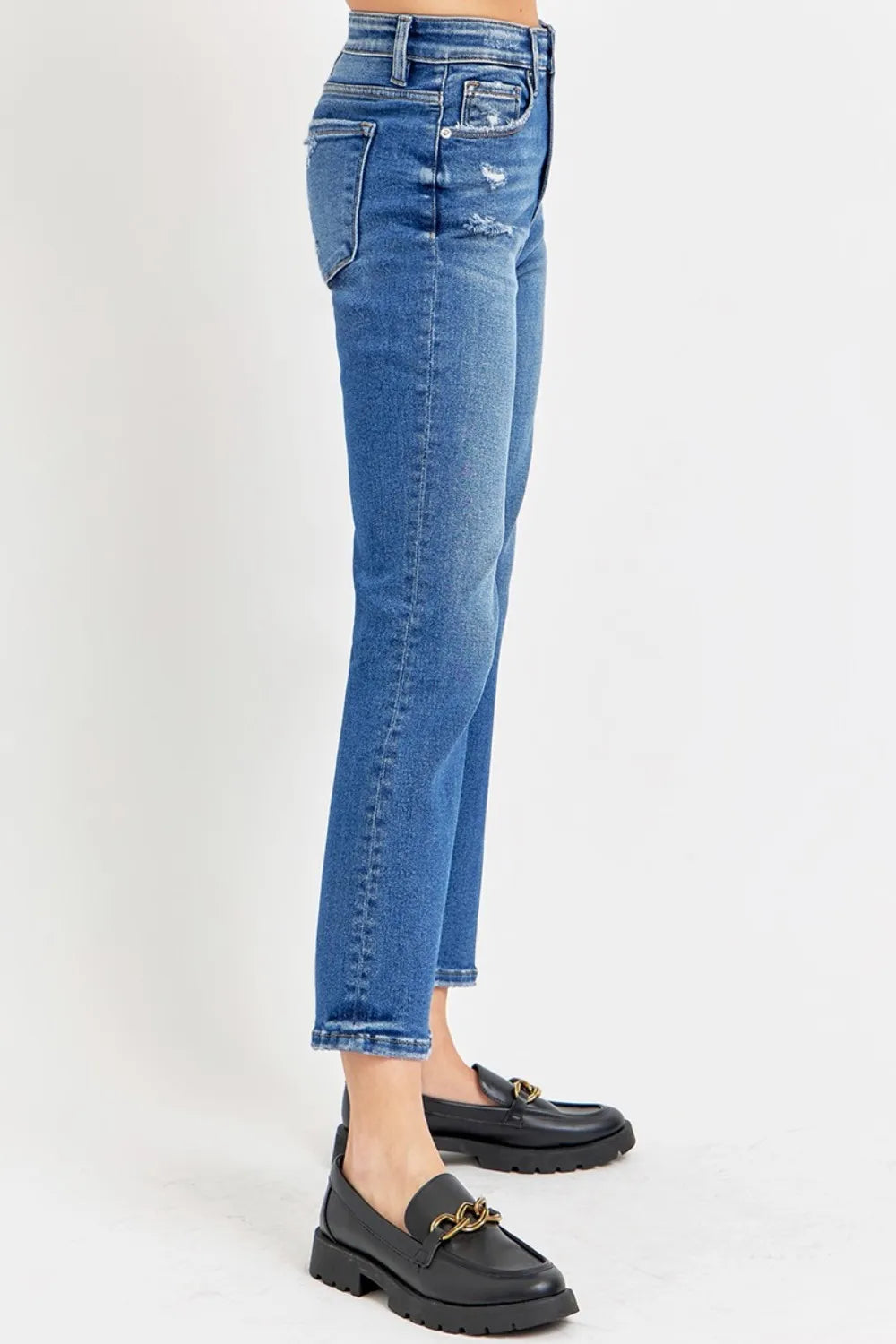 Blue jeans worn by a person on a white background