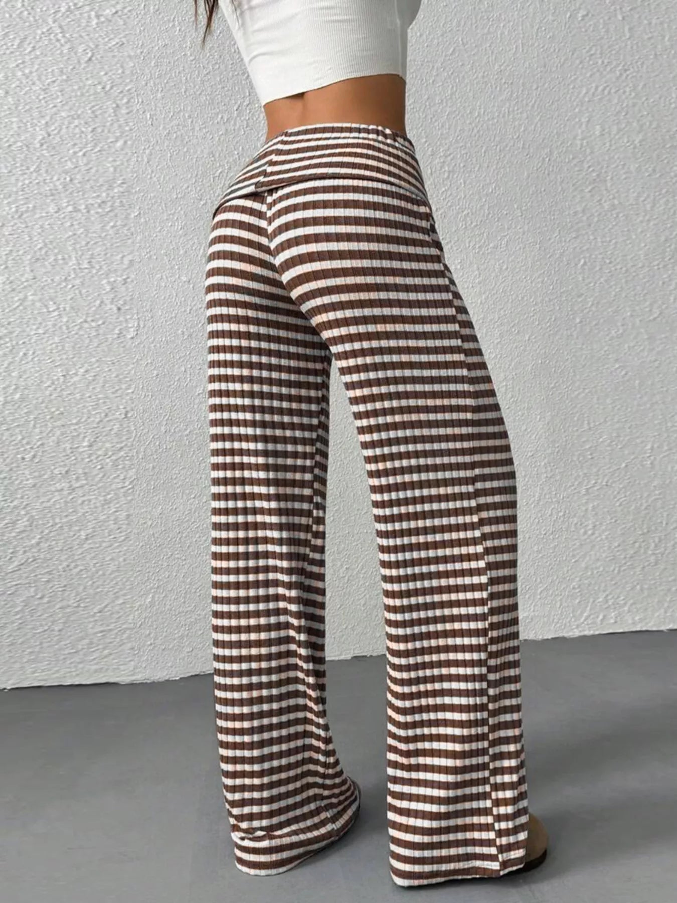Plaid pants worn by a person against a plain background
