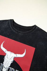 Black t-shirt with a red square and white bull skull design on a plain background