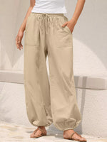Beige wide-leg pants worn by a person on a light background
