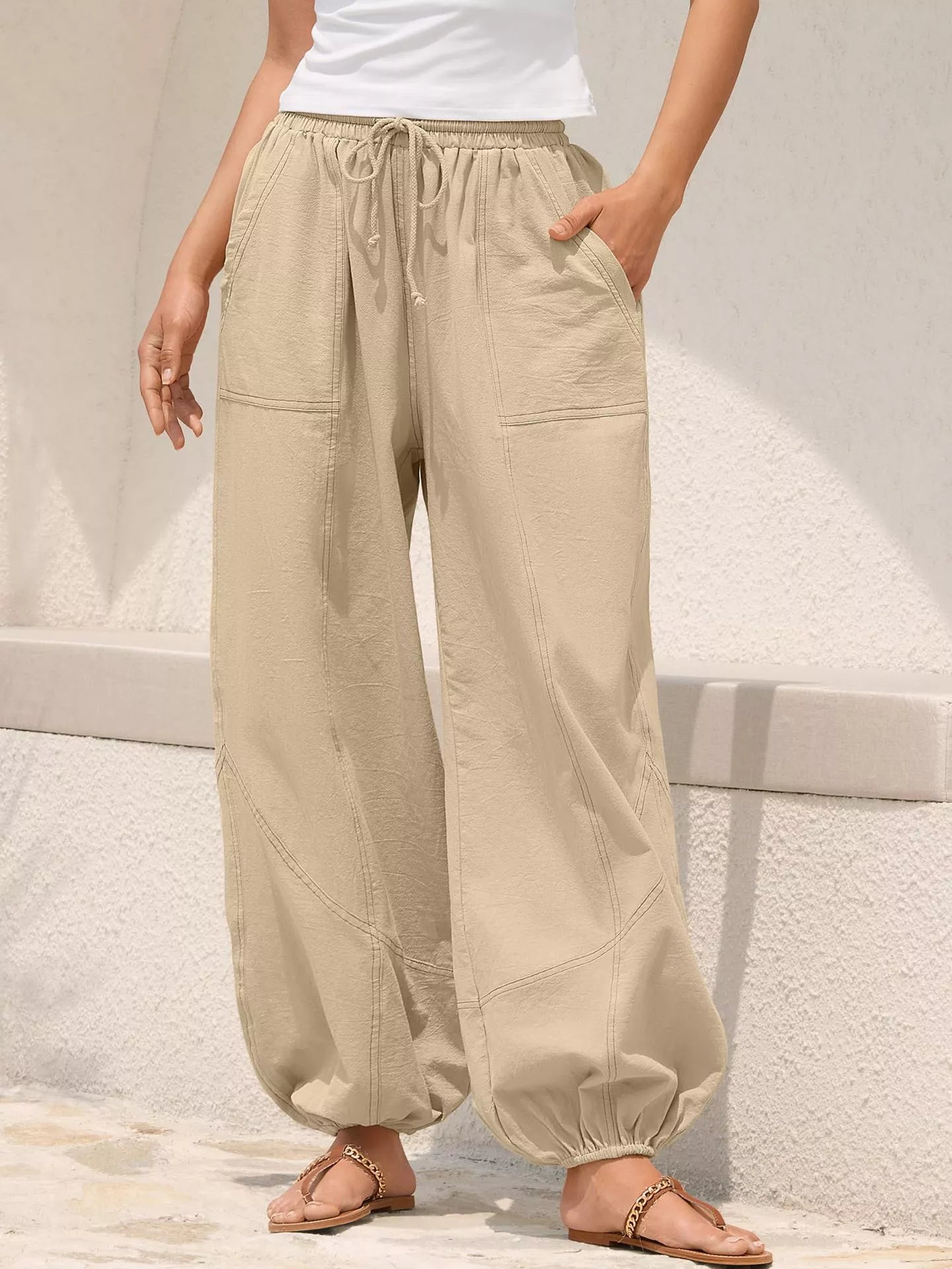 Beige wide-leg pants worn by a person on a light background