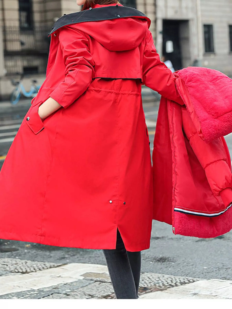 Lady showing a view from the back with her hand in her pocket of Women's Detachable Longline Hooded Parka with Faux Fur Trim and Drawstring Waist
