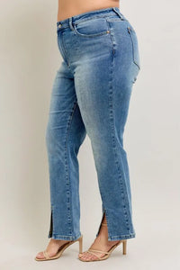Blue jeans worn by a person on a plain background