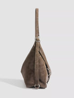 Brown leather handbag on a light gray background