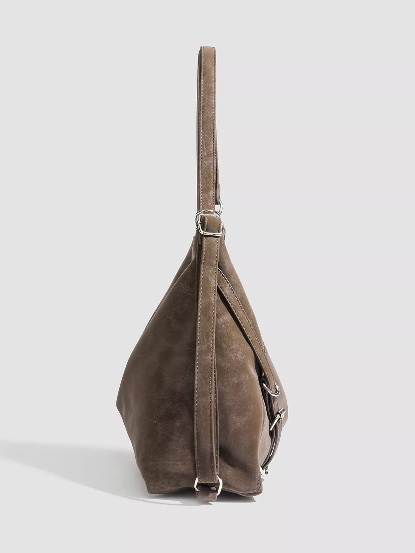 Brown leather handbag on a light gray background