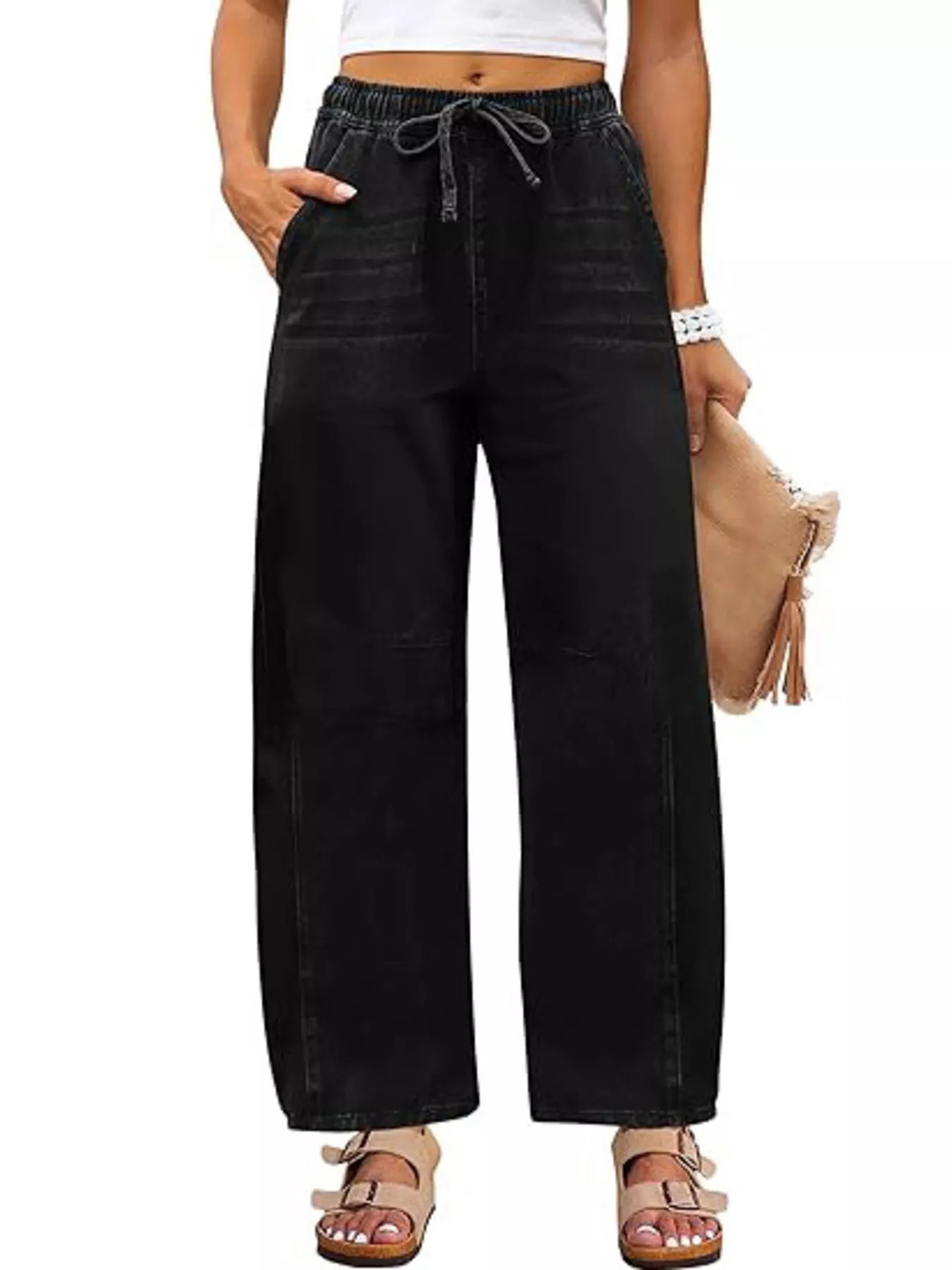 Black wide-leg pants worn by a person on a white background