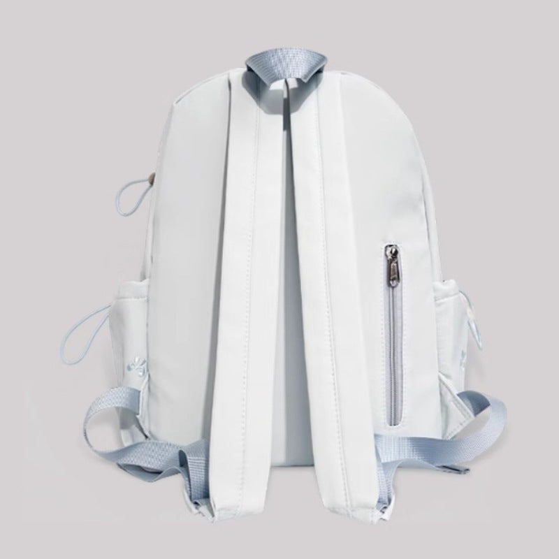 White backpack with blue accents on a light gray background