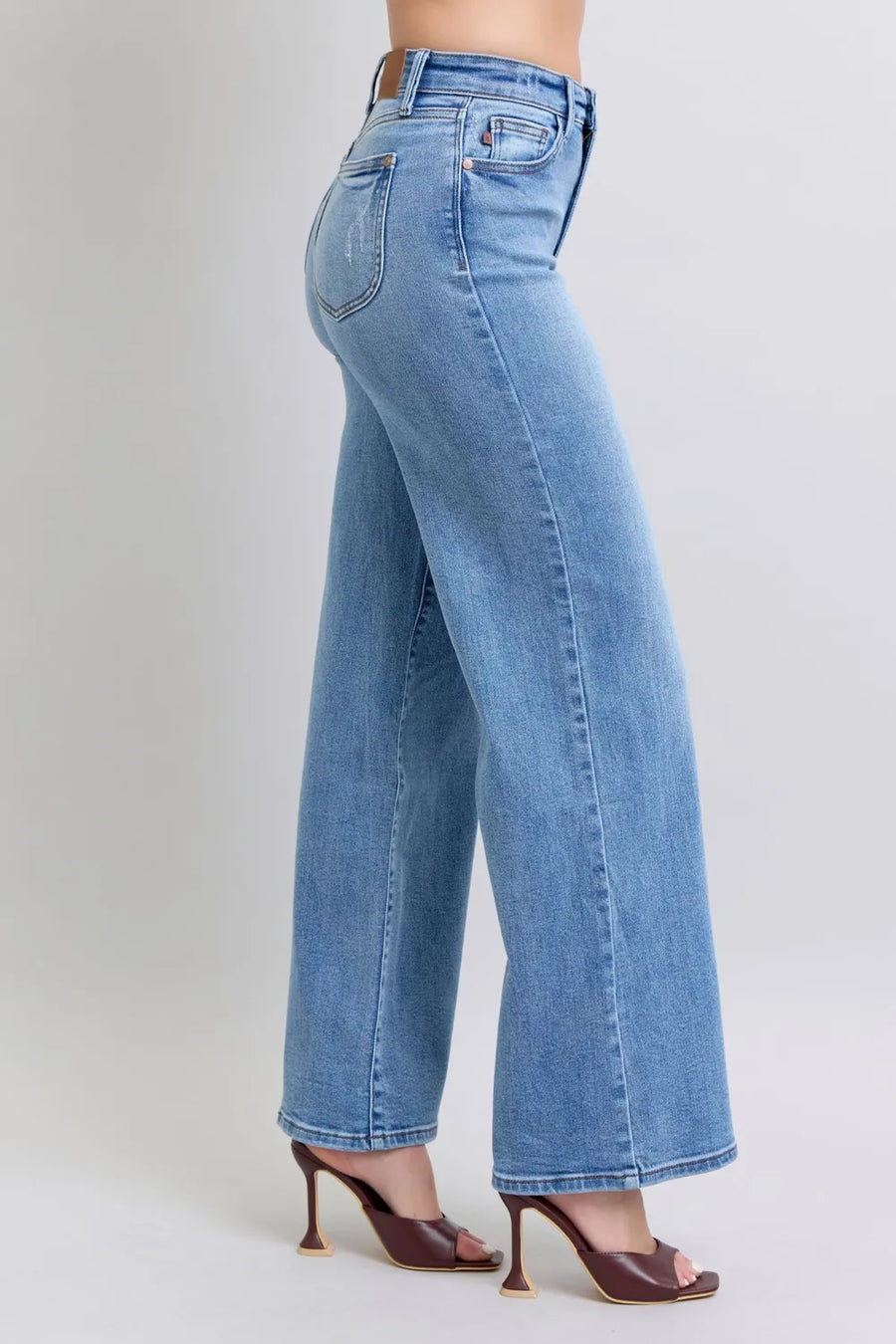 Light blue jeans worn by a person on a white background