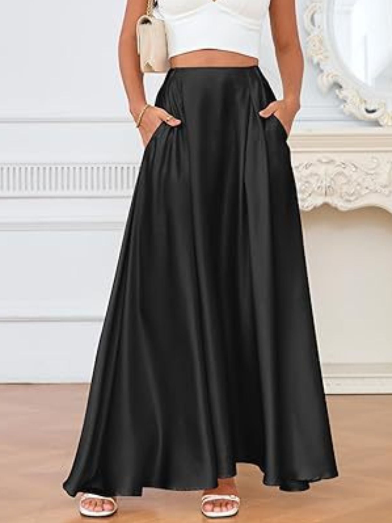 Person wearing a black skirt with a white top in an indoor setting