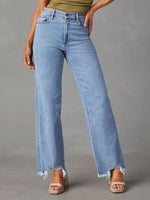 Light blue jeans worn by a person on a gray background