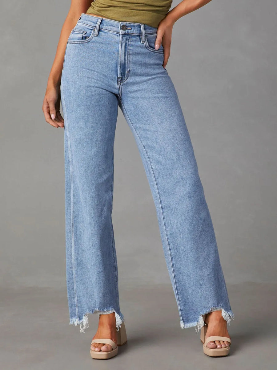 Light blue jeans worn by a person on a gray background