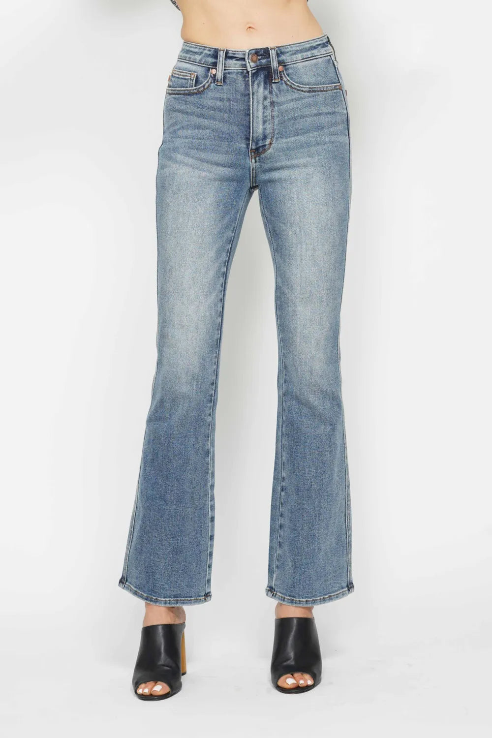 Blue jeans worn by a person on a white background