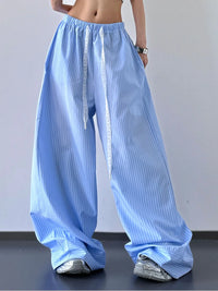 Light blue striped wide-leg pants worn by a person on a plain background