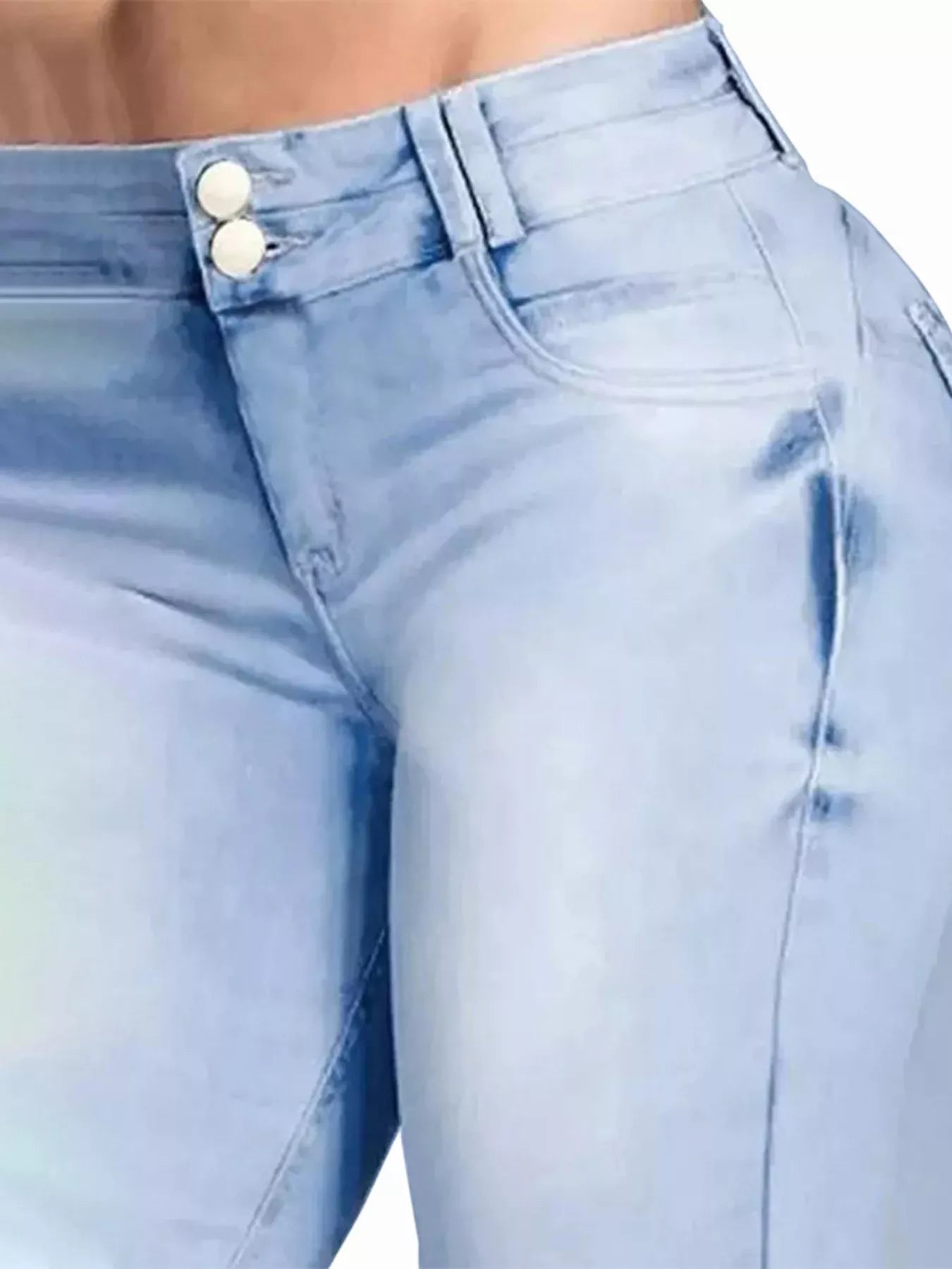 Light blue jeans with a button detail on a blurred background