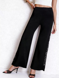 Black wide-leg pants with lace trim worn by a person on a white background