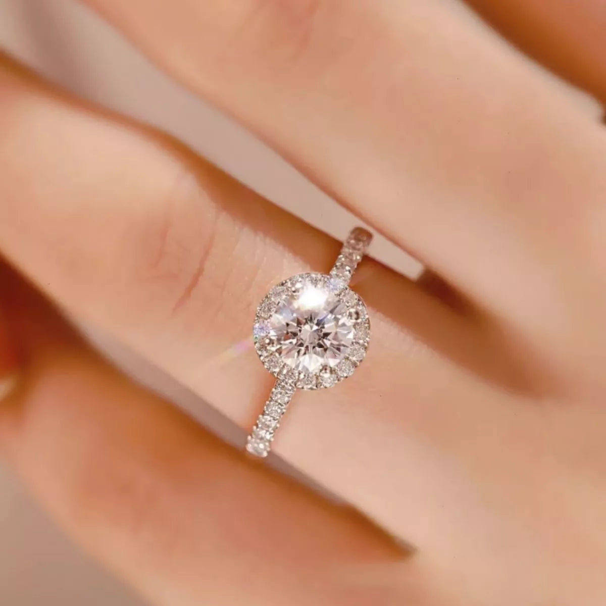 Silver ring with a large diamond on a blurred background