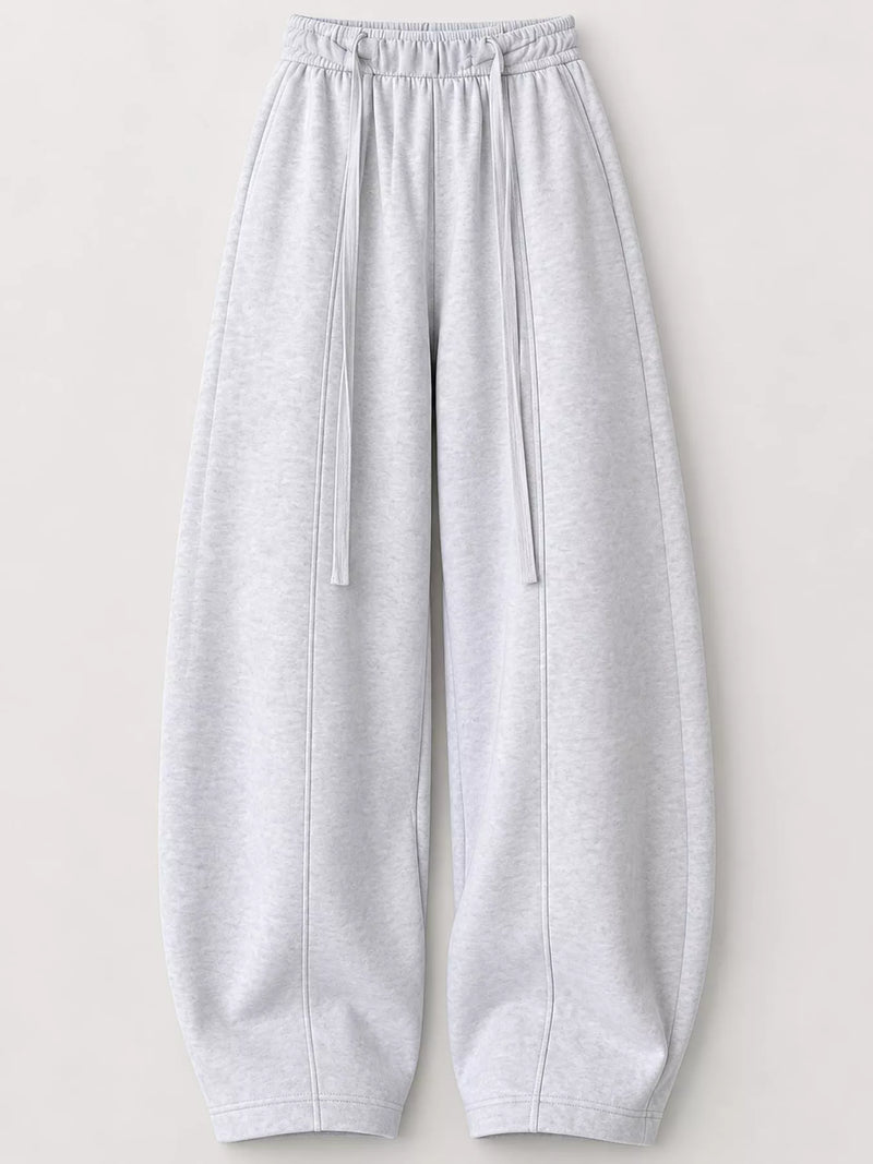 Light gray heather sweatpants with an elastic drawstring waist and wide legs, shown flat against a light beige background.