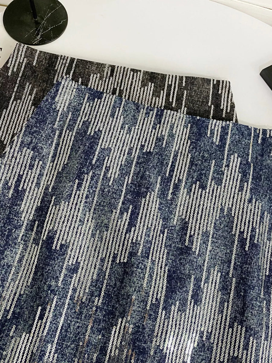 Close-up of a blue and gray patterned rug on a white floor.