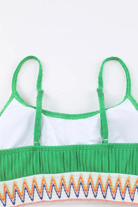 Green and white top with colorful zigzag pattern on a white background