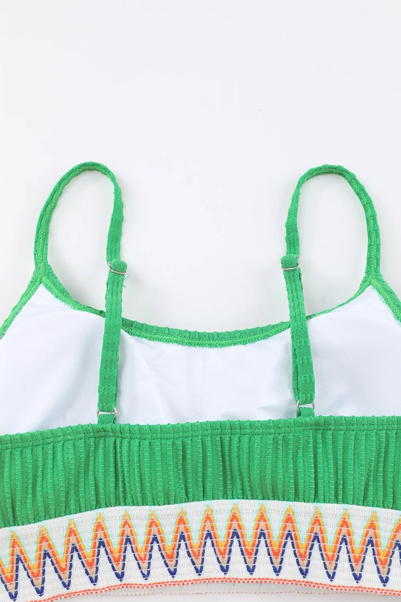Green and white top with colorful zigzag pattern on a white background